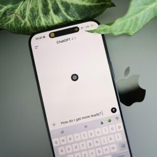Smartphone displaying an AI tool (ChatGPT) with the question, "How do I get more leads?" highlighting AI in Marketing.