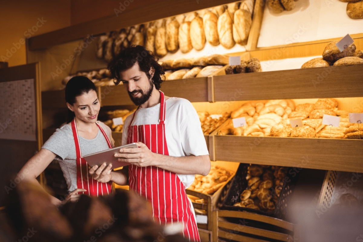 Bakery employees using a tablet to manage customer orders and get more leads