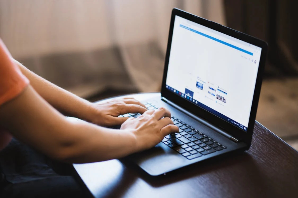 Person working on laptop implementing AI in marketing tools for business growth