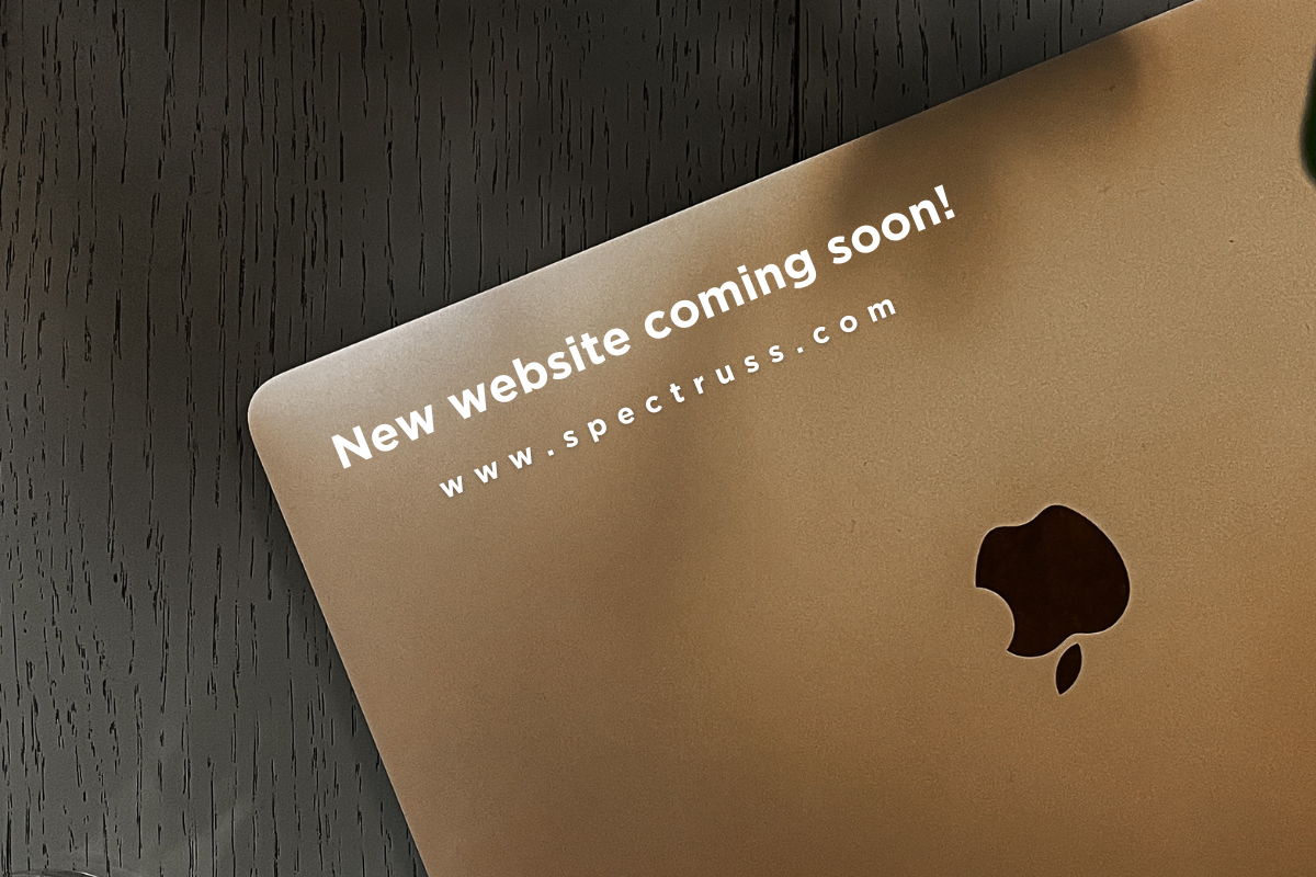 Laptop displaying "New website coming soon! www.spectruss.com" for Spectruss