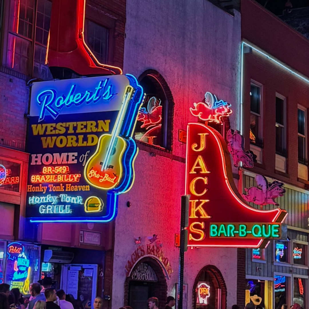 Vibrant neon signs for local businesses at night, illustrating the visual competition to Dominate Local Search Results.