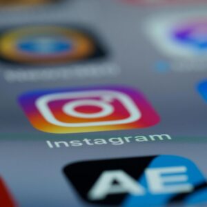 Instagram app icon on smartphone screen representing platform strategy managed by a Social Media Manager.