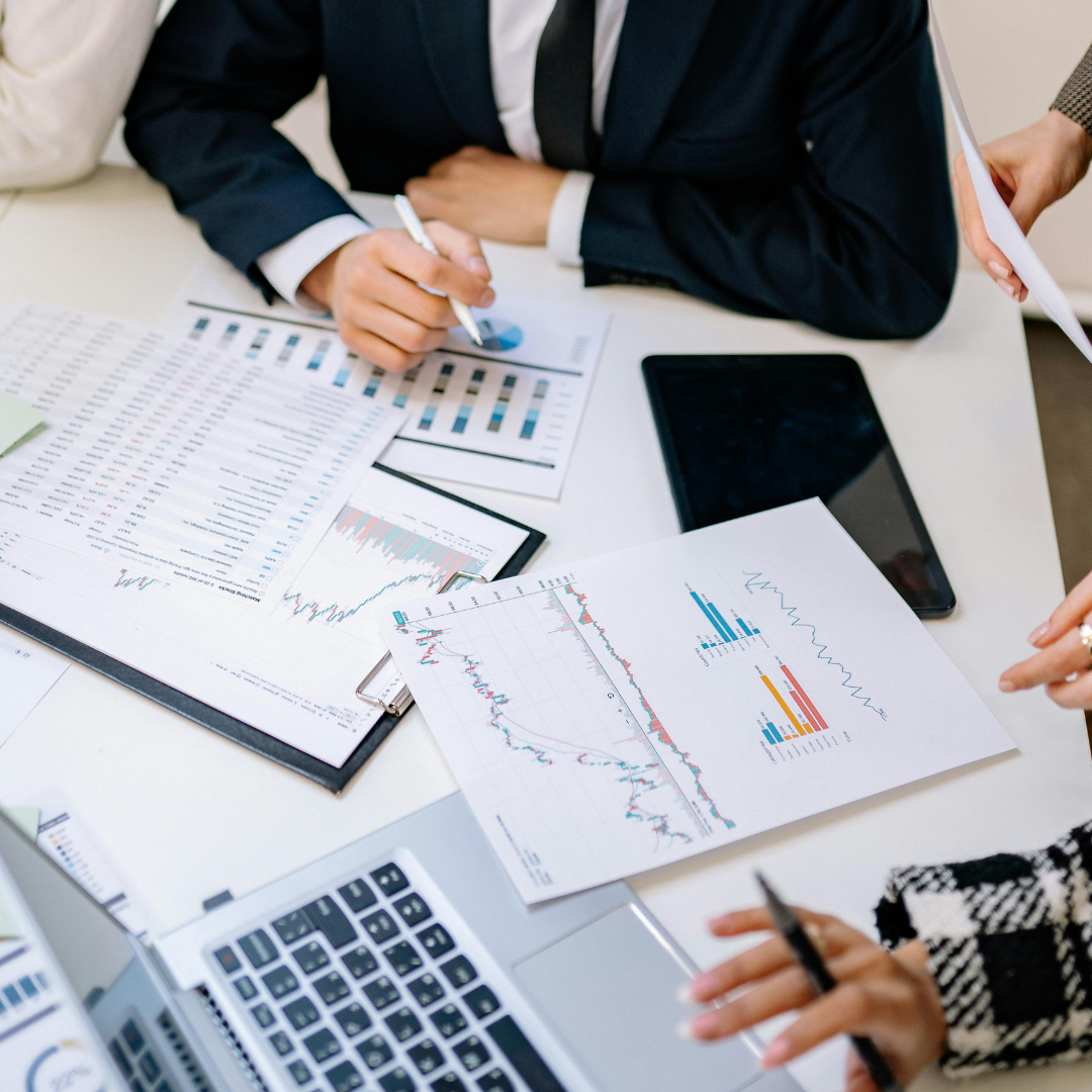 Marketing team reviewing analytics reports and charts during strategy meeting