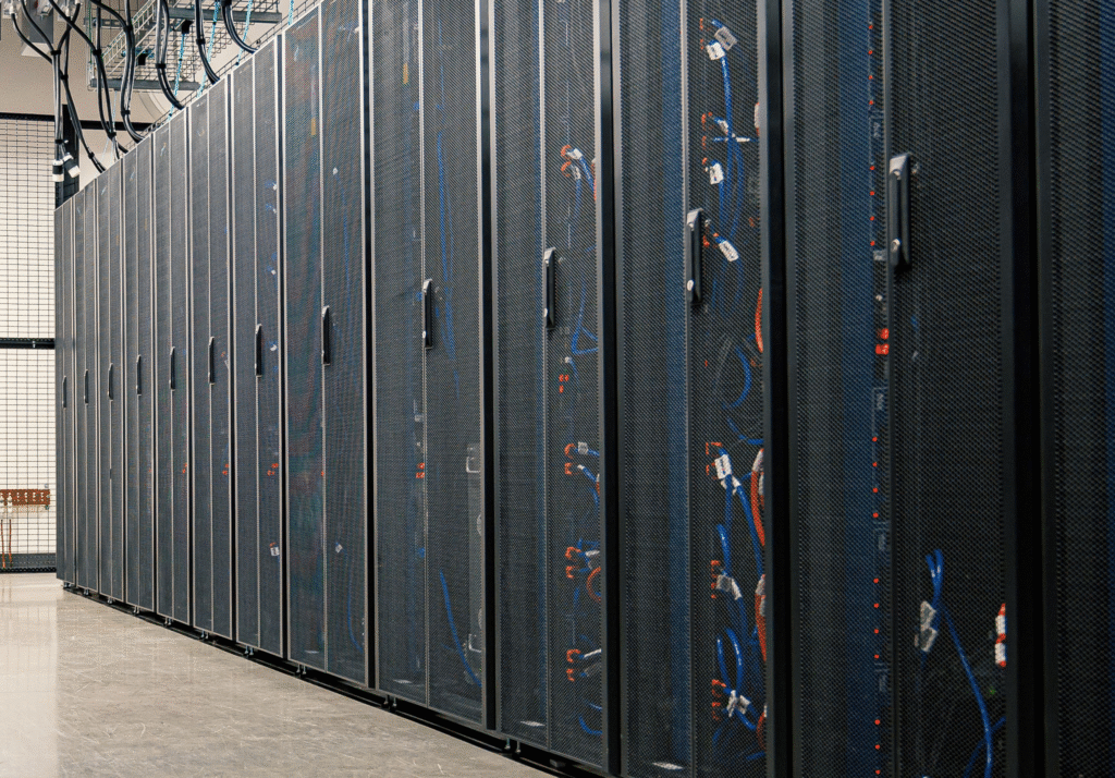 Row of server racks with network cabling inside a modern data center facility