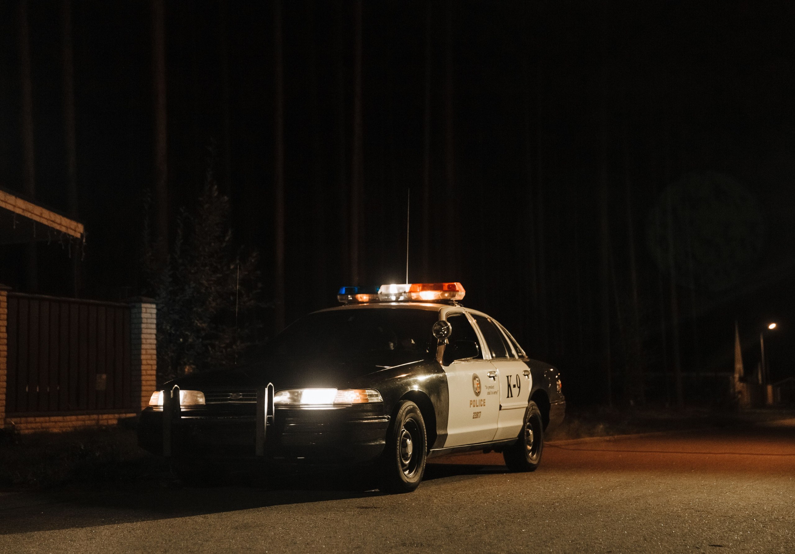 police car with blue and red lights on at night representing a DUI traffic stop in Tennessee